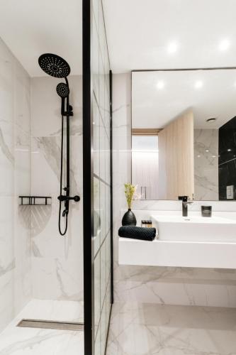 a bathroom with a shower and a sink and a tub at At Herbal Boutique Hotel & Spa in Protaras