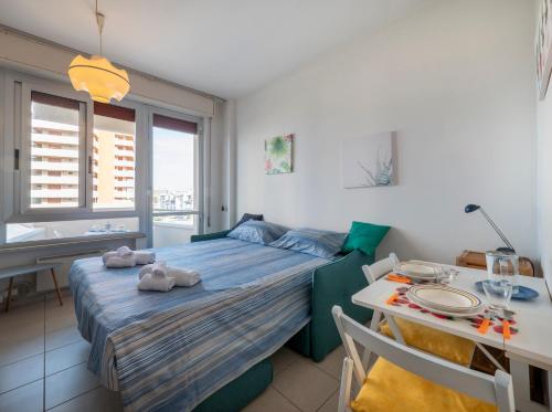 a bedroom with a bed and a table and a dining room at Mimose Little House in Misano Adriatico