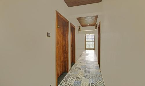 a hallway with a tile floor in a house at Treebo Royal Imperio, Hinjewadi in Pune