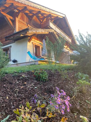a house with a garden in front of it at La Ferme des Georgières "Séjour en tout compris" in Notre-Dame-de-Bellecombe
