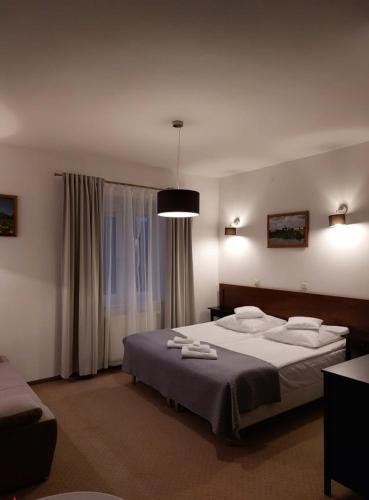 a bedroom with a large bed with towels on it at Sandomiria in Sandomierz
