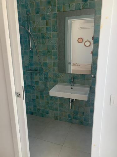 a bathroom with a sink and a mirror at Charmant logement front port et Mer in Port El Kantaoui