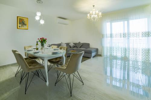 a living room with a table and chairs and a couch at VILLA REBECCA, Muć - Split in Gornji Muć