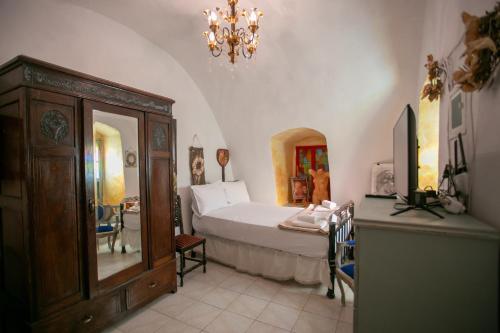 a bedroom with a bed and a chandelier at Charouda country house in Pirgos Dhirou