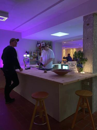 a man standing at a bar in a restaurant at Balestrand Hotel in Balestrand