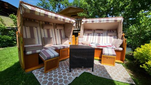 a large wooden camper with a table and chairs at Ferienhaus AB in Söll