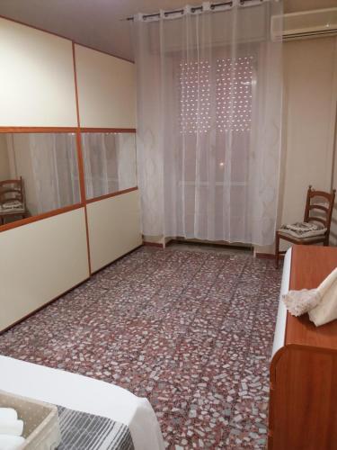 an empty room with a bed and a window at Casa Narciso tra mare e canyon ad Avola in Avola