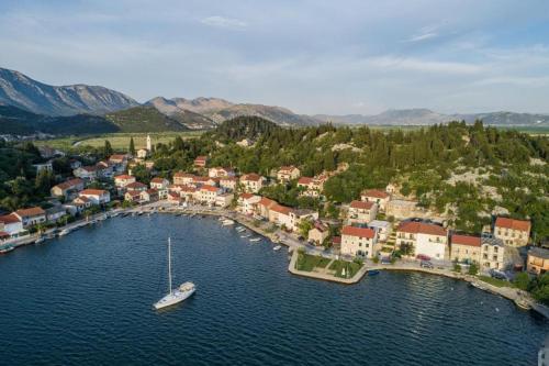 an aerial view of a small town with a boat in the water at Holiday home TONČICA - Rogotin in Rogotin