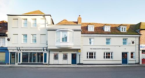 a row of white buildings on a street at The Merchant's House, BW Signature Collection in Salisbury