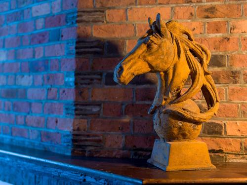 a statue of a horse in front of a brick wall at The Merchant's House, BW Signature Collection in Salisbury
