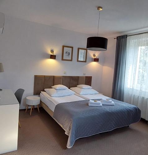 a bedroom with a large bed and a window at Sandomiria in Sandomierz