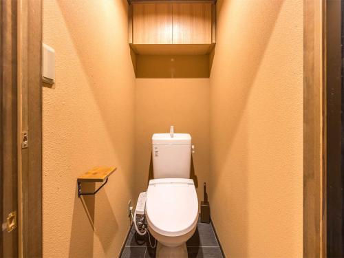 a small bathroom with a toilet in a stall at 慶有魚·小松(Kyotofish·Komatsu) in Kyoto