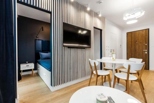 a room with a table and chairs and a bedroom at Uroczy Apartament w Centrum Starego Miasta in Gdańsk