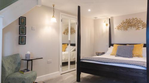a bedroom with a bed and a mirror at Hillside Haven, panoramic views Nr Bakewell in Great Rowsley