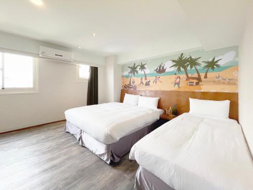 a hotel room with two beds and a painting on the wall at Roaders Hotel Hualien Dongda in Hualien City
