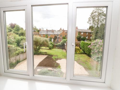 an open window with a view of a house at The Old Bakery in Chipping Norton
