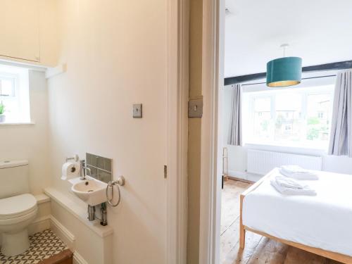 a bathroom with a toilet and a sink at The Old Bakery in Chipping Norton