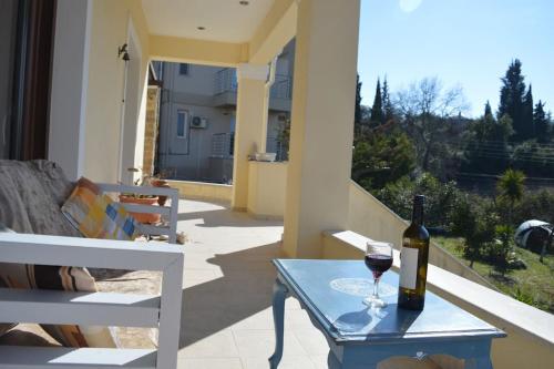 a bottle of wine and a glass on a table at Villa Elm in Pouládes