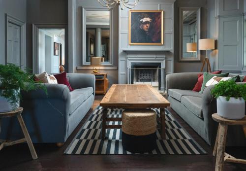 a living room with two couches and a coffee table at Moonfleet Manor Hotel in Weymouth