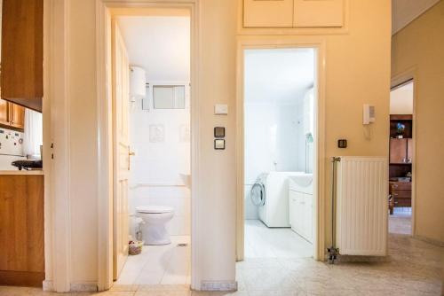 a bathroom with a toilet and a bath tub at STEFANOS HOUSE in Argostoli