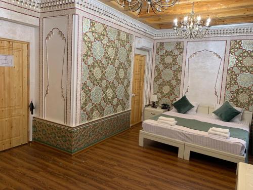 a bedroom with a bed and a chandelier at Shohnishin Boutique in Bukhara