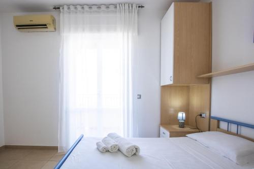 ガリポリにあるle terrazze sul mare gallipoliのベッドルーム1室(窓のあるベッド1台、タオル付)