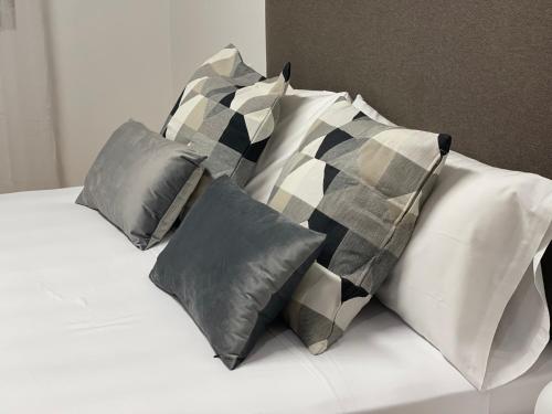 a white bed with four pillows on it at Oktheway Pedro Saco Street 2 in Sarria