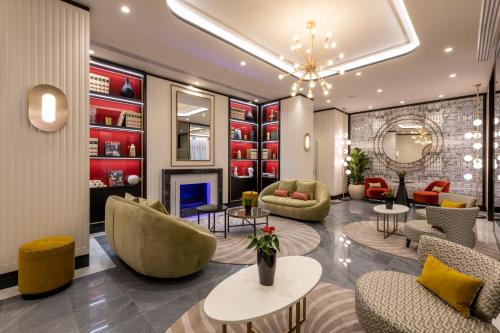 a lobby with couches and chairs and a fireplace at H10 Palazzo Galla in Rome