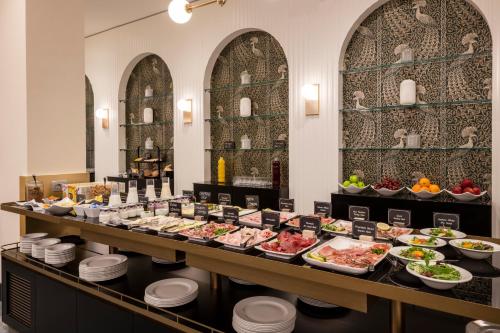 a buffet line with food on a table at H10 Palazzo Galla in Rome