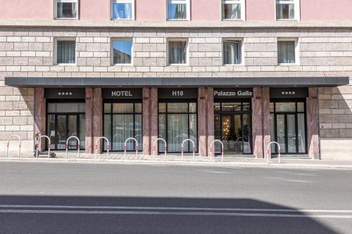 a building with glass doors on the side of a street at H10 Palazzo Galla in Rome