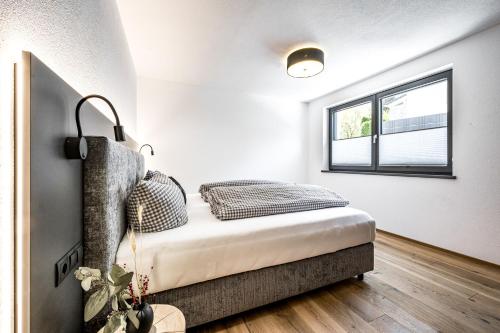 a bedroom with a bed and a window at Mountain Moments in Sautens