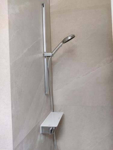 a shower with a shower head in a bathroom at Schicke Wohnungen in Stadtnähe in Würzburg