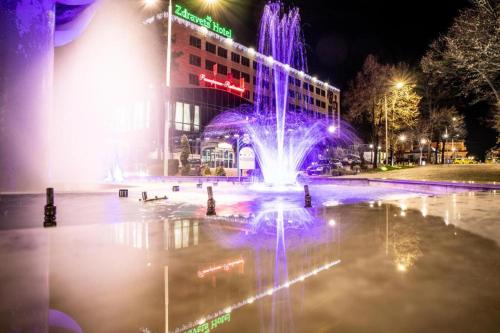 a fountain in front of a building at night at Zdravets SPA Hotel in Velingrad