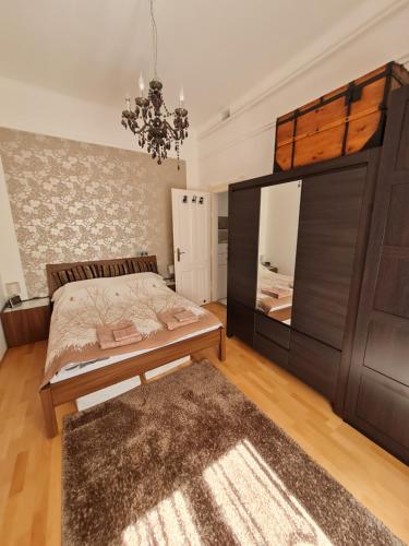 a bedroom with a large bed and a mirror at Marble Apartment -near Buda castle in Budapest