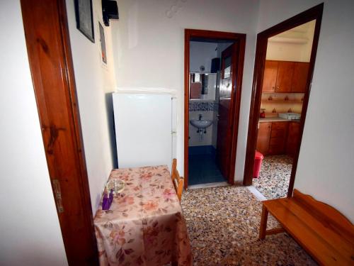a kitchen with a refrigerator and a table in a room at Mega Apartments in Tiros