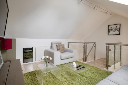 a living room with a couch and a chair at Central top floor apartment in Stavanger