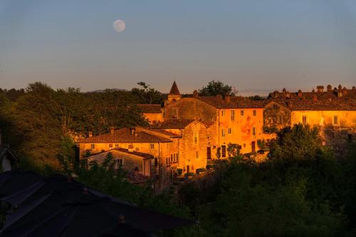 a group of buildings in a city at sunset at Il Borro Relais & Châteaux in San Giustino Valdarno