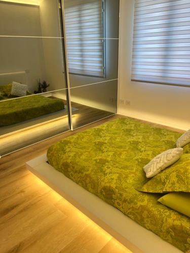 a bedroom with a bed and a large window at Ferrarese209 in Bologna
