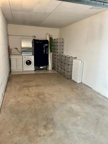 an empty garage with a washer and dryer in it at Ferrarese209 in Bologna