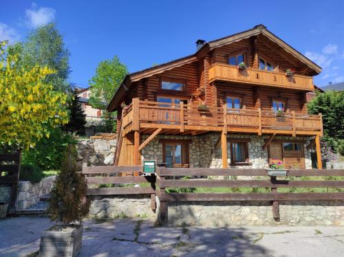 a wooden house with a bench in front of it at Chalet Le Cambre d'Aze in Font-Romeu