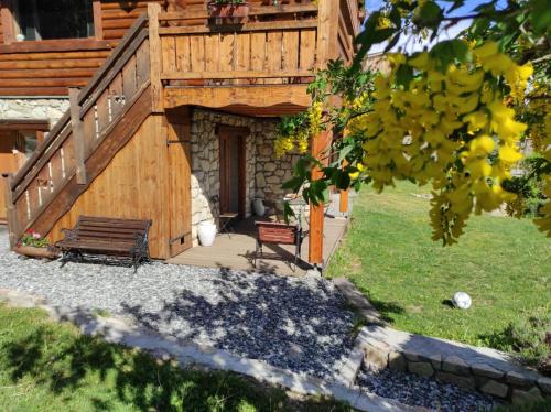 a wooden cabin with a bench and a porch at Chalet Le Cambre d'Aze in Font-Romeu