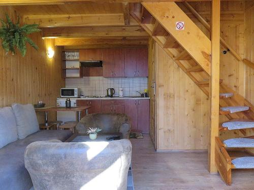 a living room with a couch and a kitchen at Domki ogrzewane Sokół in Władysławowo