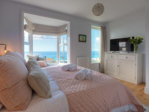 a bedroom with a large bed with towels on it at Marchbourne in St Ives