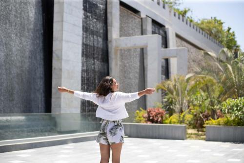 a woman standing in front of a building with her arms out at Ocean Blue Studios in Cairo