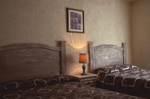 Postel nebo postele na pokoji v ubytování Posada del Carmen