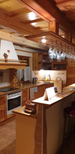a large kitchen with wooden cabinets and a counter top at Chaty Helena in Vyšná Boca