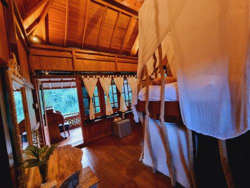 a bedroom with a bed in a room at Avalon Ubud Castle & SPA in Ubud