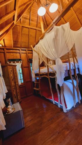 a bedroom with two bunk beds in a room at Avalon Ubud Castle & SPA in Ubud