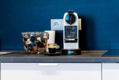 a kitchen counter with a blender and a cup of coffee at Wien-Appartement, Contactless - Self-Check-In in Vienna