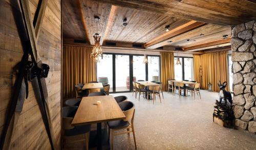 a restaurant with tables and chairs in a room at Apartmany Demänovka in Demanovska Dolina